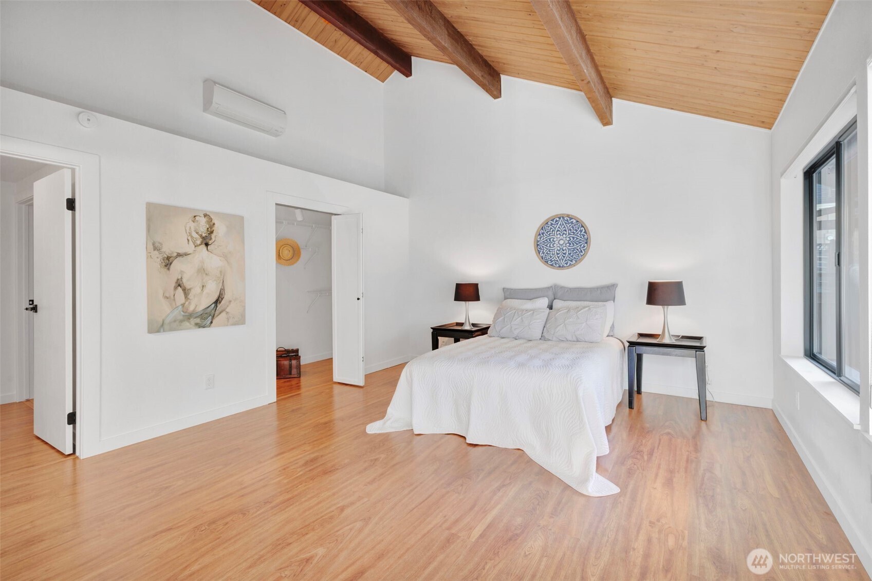 144 Amherst Street Fircrest, WA 98466 - Photo 15 of 39 a bedroom with a large bed and a chandelier