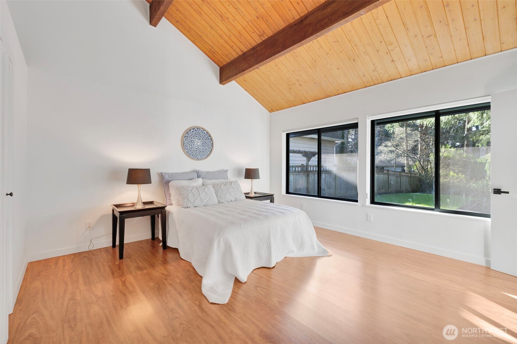 144 Amherst Street Fircrest, WA 98466 - Photo 16 of 39 a bedroom with a large bed and a large window