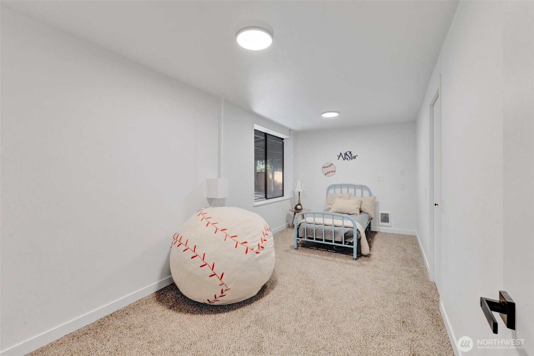 144 Amherst Street Fircrest, WA 98466 - Photo 29 of 39 a bedroom with a bed and a chandelier