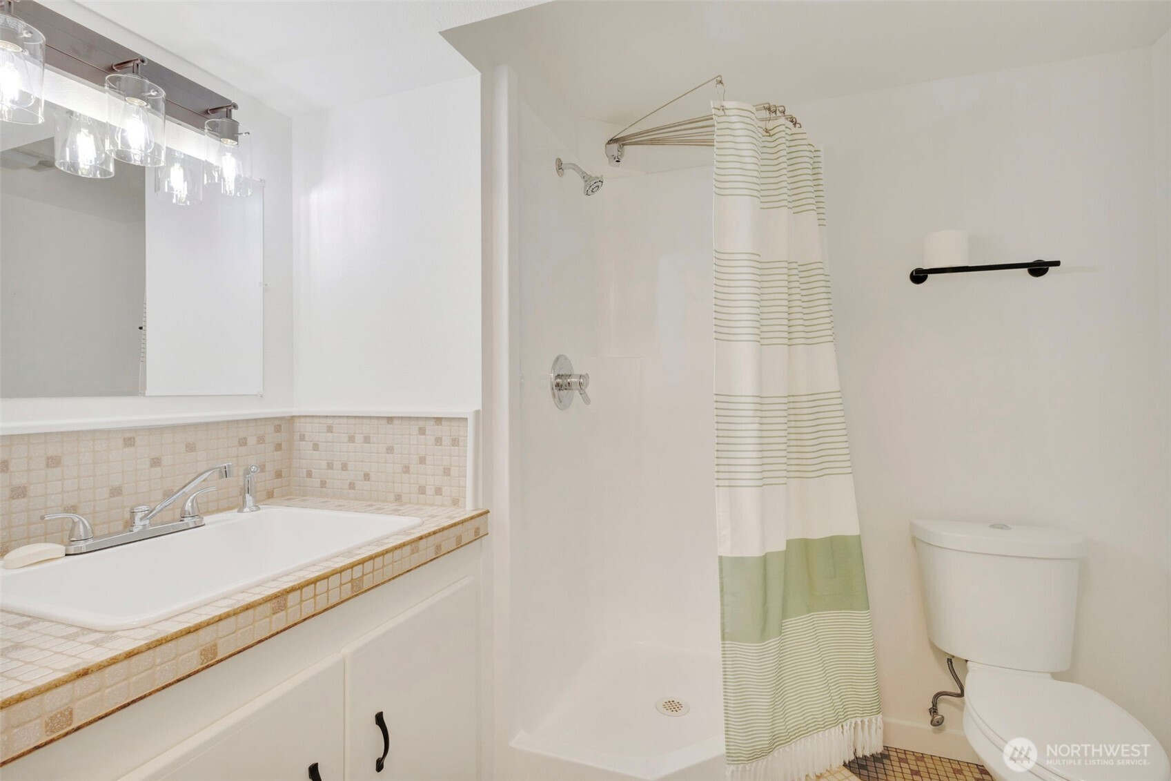 144 Amherst Street Fircrest, WA 98466 - Photo 31 of 39 a bathroom with a granite countertop sink a toilet and shower