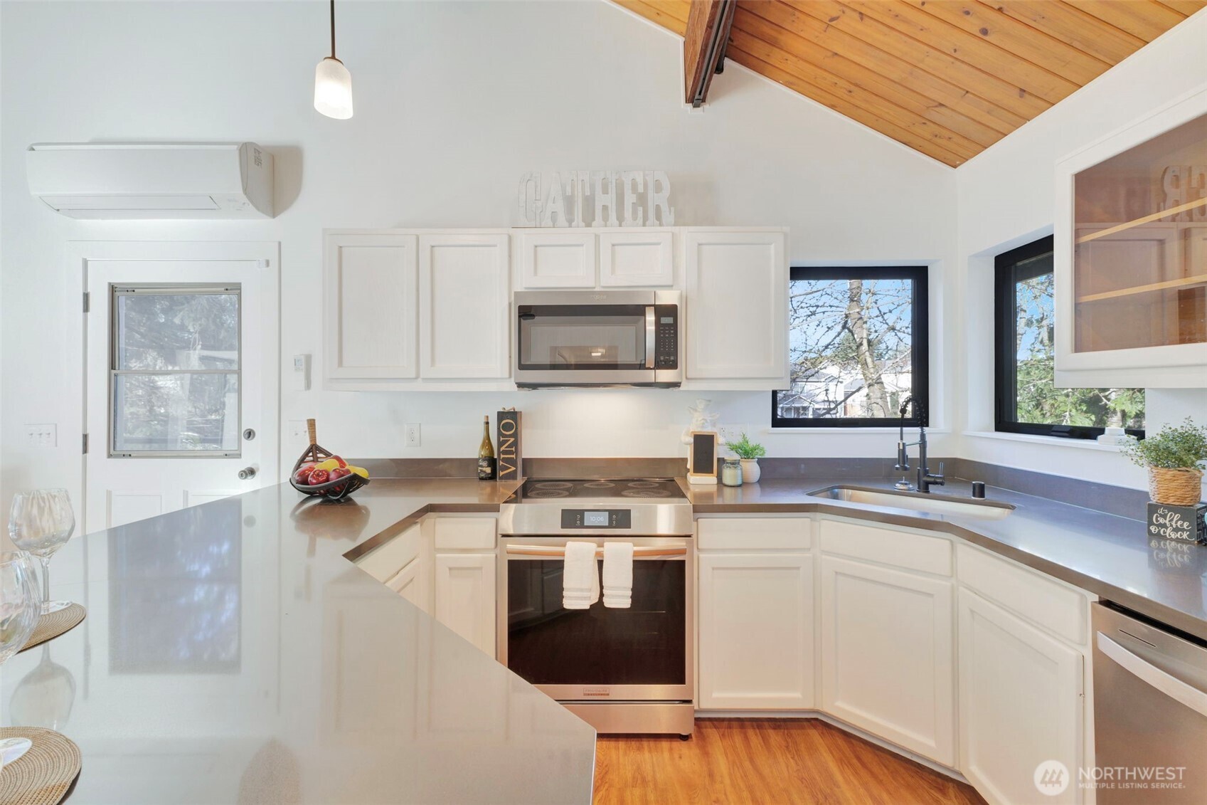 144 Amherst Street Fircrest, WA 98466 - Photo 7 of 39 a kitchen with stainless steel appliances a stove sink microwave and cabinets