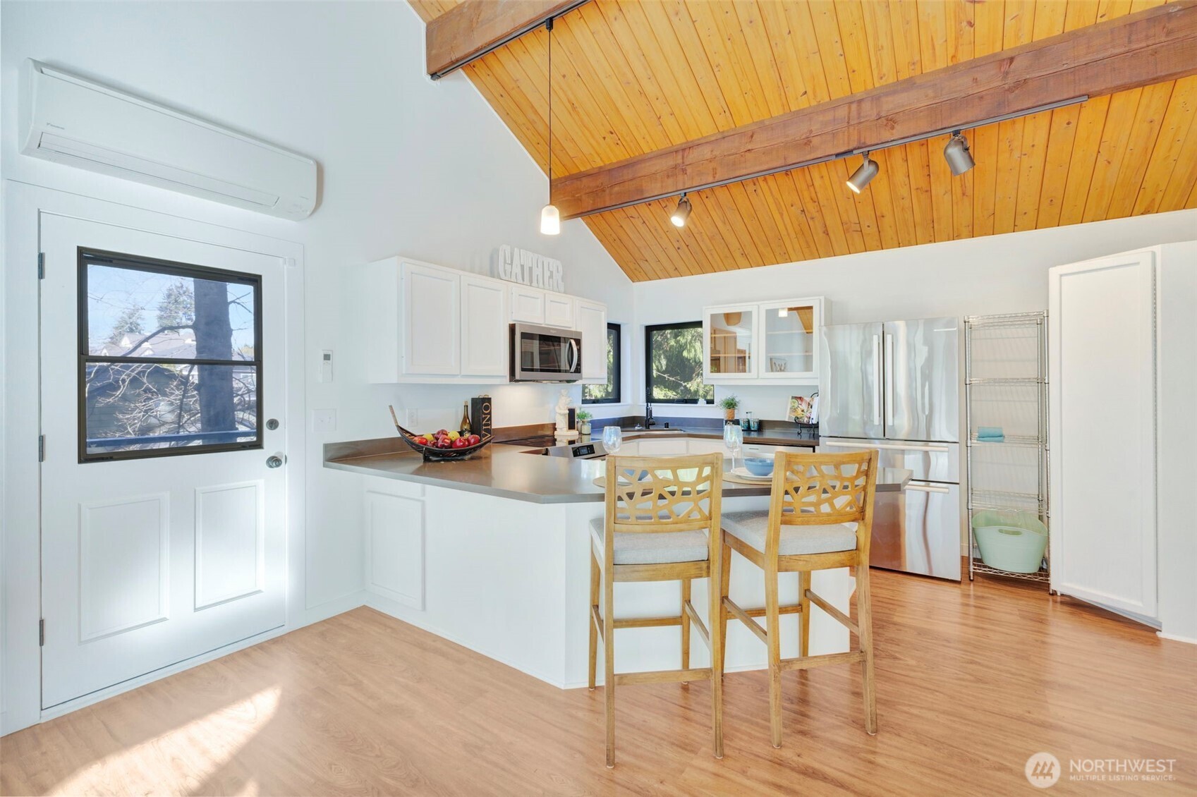 144 Amherst Street Fircrest, WA 98466 - Photo 9 of 39 a kitchen with stainless steel appliances granite countertop a refrigerator and microwave with wooden floor