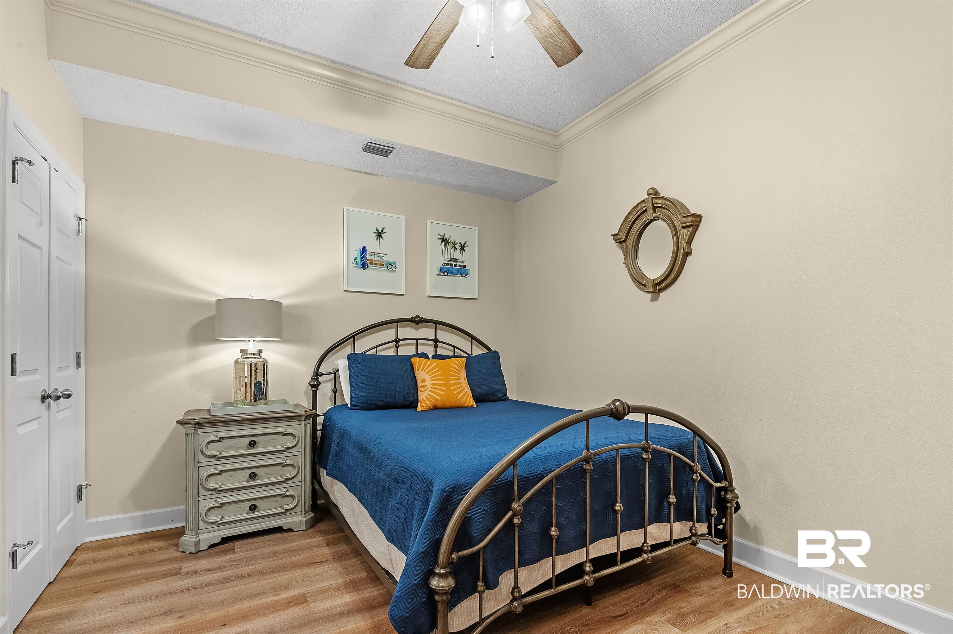 27582 Canal Road, Unit 2104 Orange Beach, AL 36561 - Photo 26 of 35 Bedroom featuring ornamental molding, hardwood / wood-style floors, ceiling fan, and a closet