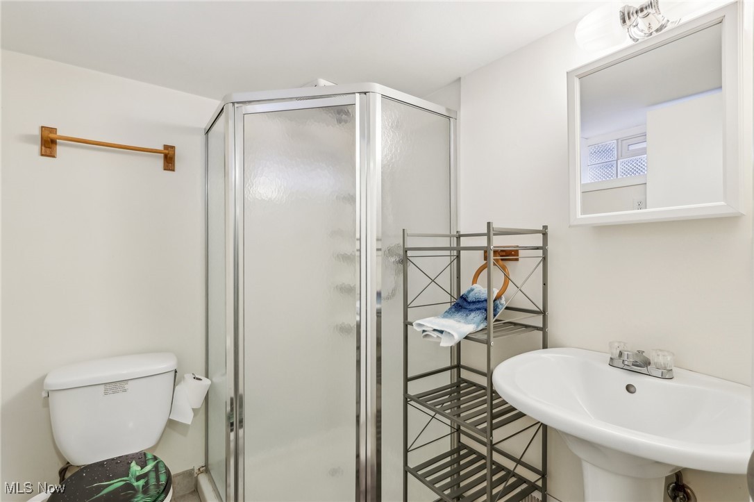 1573 Roselawn Road Cleveland, OH 44124 - Photo 14 of 25 Bathroom with toilet, a shower with shower door, and sink