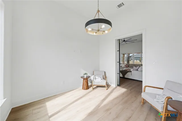 a room with a bed and a chandelier