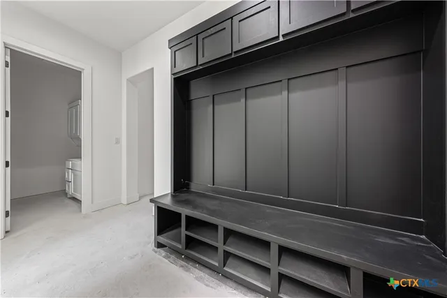 a view of a room with a hanging ceiling fan