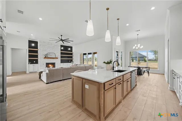a kitchen with counter top space and wooden floor
