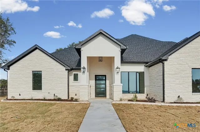 a front view of a house with a yard