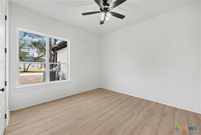 wooden floor in an empty room with a window