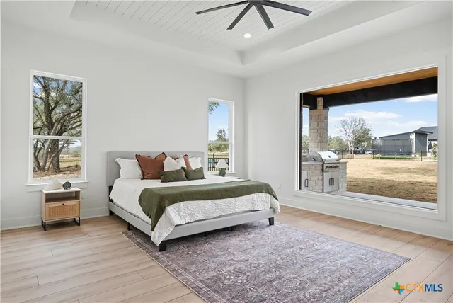 a spacious bedroom with a large bed and a wooden floor
