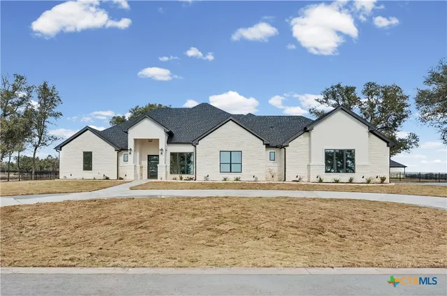 a view of a white house with a yard