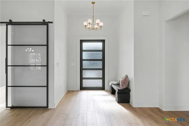 a bedroom with a bed and a chandelier