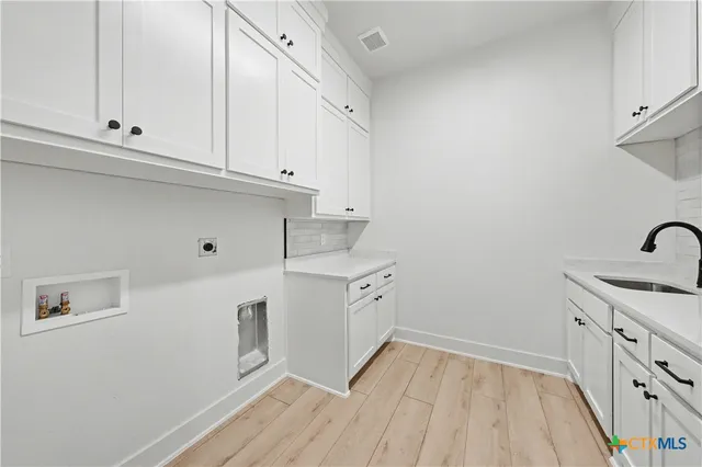 a view of a white house with a big yard and large trees