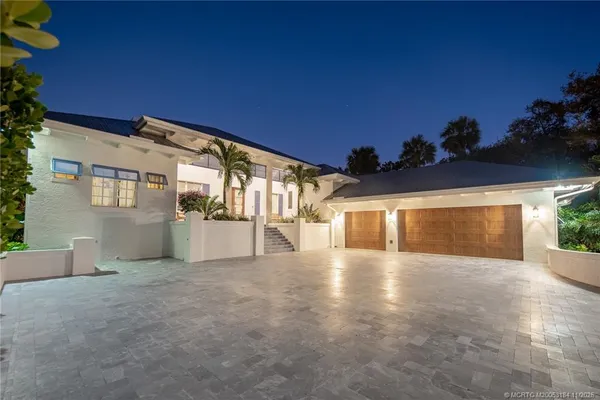 a view of a dining room with furniture water view and wooden floor