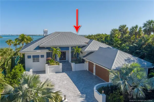 a backyard of a house with barbeque oven table and chairs