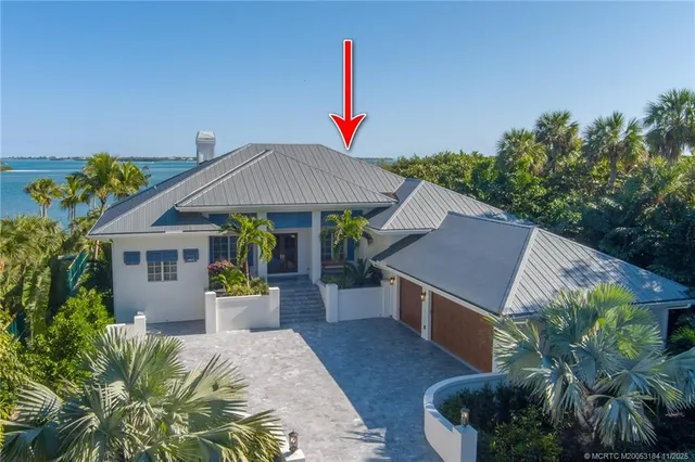 a backyard of a house with barbeque oven table and chairs