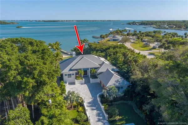 a view of a patio with a table and chairs under an umbrella