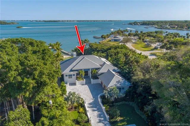 a view of a patio with a table and chairs under an umbrella