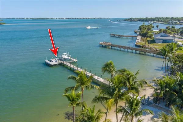 a patio with a table and chairs under an umbrella