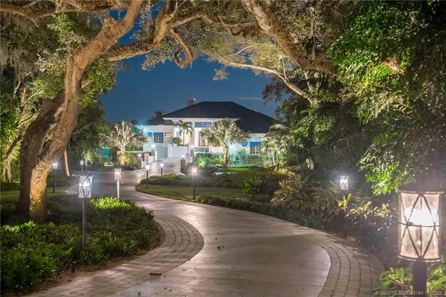 a view of a swimming pool with a patio and a yard