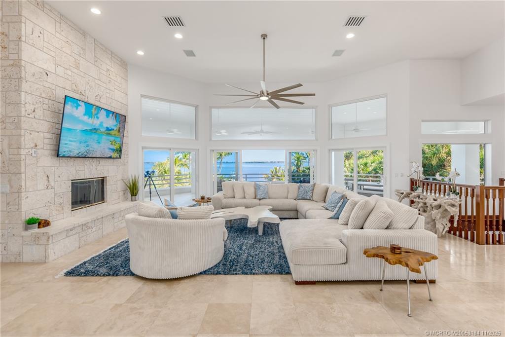 3365 Southeast St Lucie Boulevard Stuart, FL 34997 - Photo 27 of 94 a living room with fireplace furniture and a flat screen tv