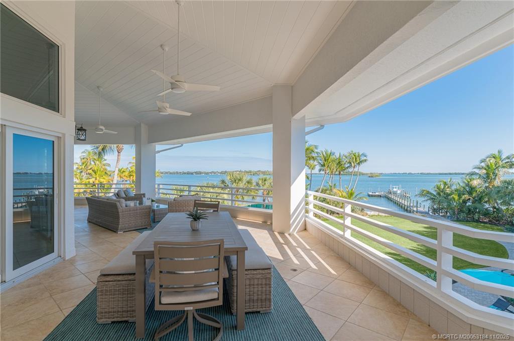 3365 Southeast St Lucie Boulevard Stuart, FL 34997 - Photo 29 of 94 a view of a dining room with furniture water view and wooden floor