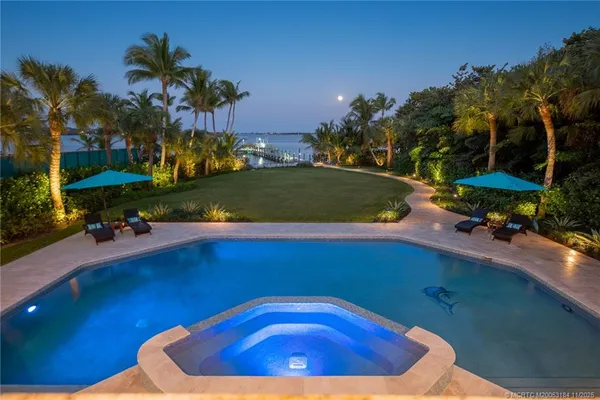 a view of a house with a small yard and plants