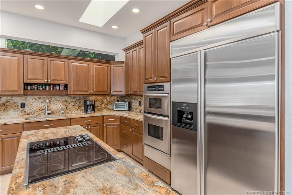 3365 Southeast St Lucie Boulevard Stuart, FL 34997 - Photo 36 of 94 a kitchen with a refrigerator stove top oven and sink