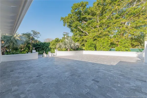 a view of a dining room with furniture and a chandelier