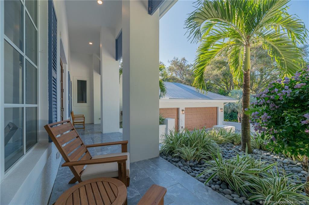 3365 Southeast St Lucie Boulevard Stuart, FL 34997 - Photo 38 of 94 a backyard of a house with barbeque oven table and chairs