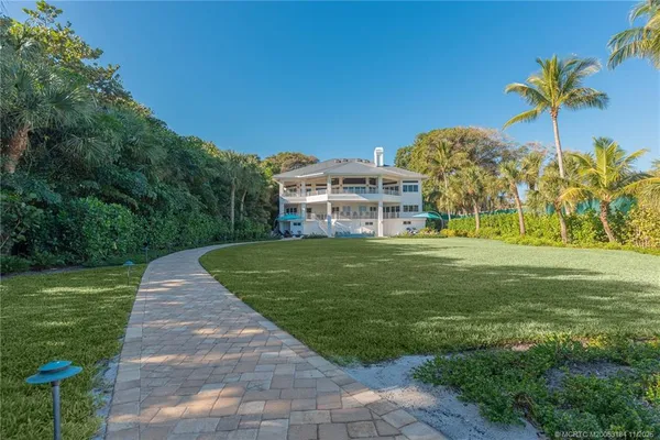 a spacious bathroom with a double vanity sink a mirror and a shower