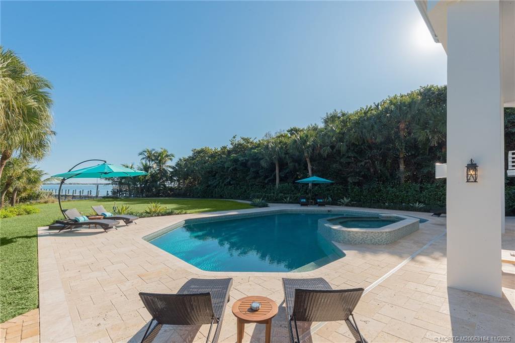 3365 Southeast St Lucie Boulevard Stuart, FL 34997 - Photo 46 of 94 a view of a swimming pool and lounge chair