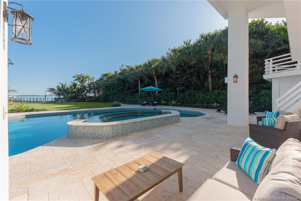 3365 Southeast St Lucie Boulevard Stuart, FL 34997 - Photo 50 of 94 a view of a swimming pool with a couches in a patio