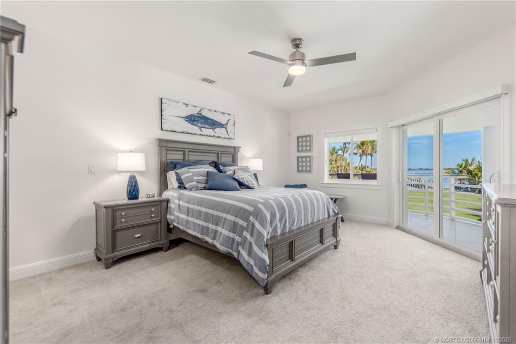 3365 Southeast St Lucie Boulevard Stuart, FL 34997 - Photo 85 of 94 a bedroom with a bed a dresser and next to a window