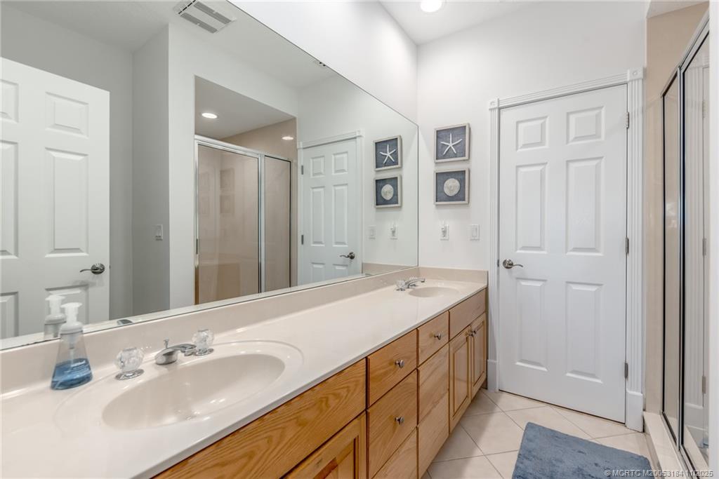 3365 Southeast St Lucie Boulevard Stuart, FL 34997 - Photo 86 of 94 a spacious bathroom with a double vanity sink a mirror and a shower