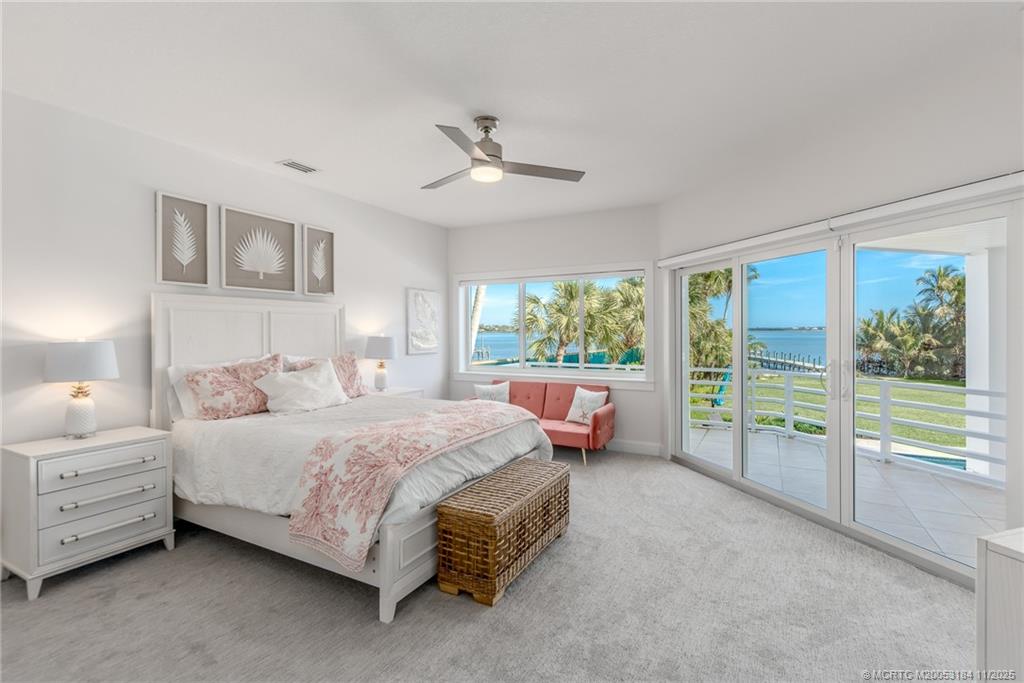 3365 Southeast St Lucie Boulevard Stuart, FL 34997 - Photo 91 of 94 a spacious bedroom with a bed and a couch