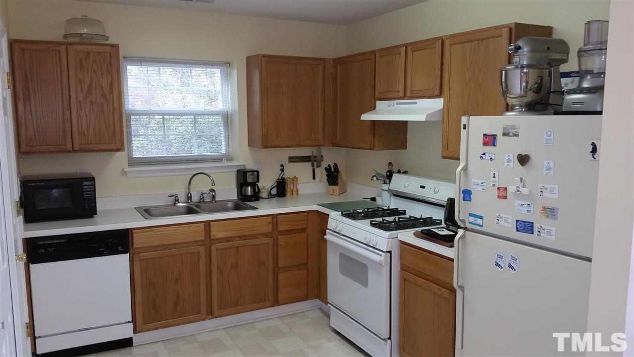 5029 Gable Ridge Drive Durham, NC 27713 - Photo 2 of 11 a kitchen with stainless steel appliances a stove a sink and a refrigerator