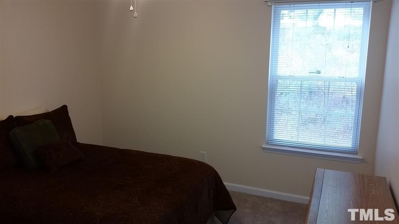 5029 Gable Ridge Drive Durham, NC 27713 - Photo 7 of 11 a view of a bedroom with a window