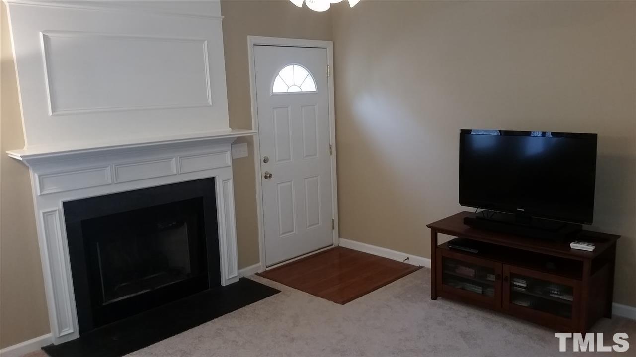 5029 Gable Ridge Drive Durham, NC 27713 - Photo 8 of 11 a living room with a flat screen tv and a fireplace