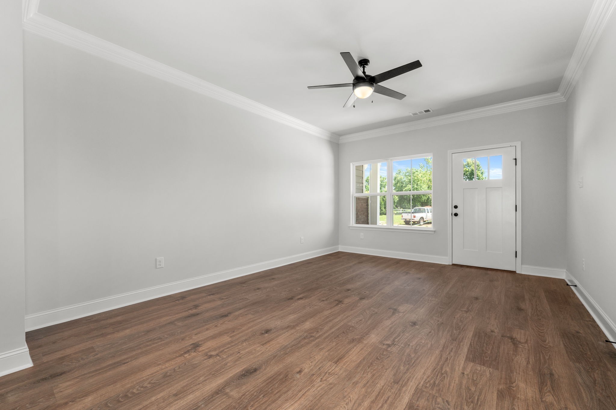 511 Rohan Drive Murfreesboro, TN 37129 - Photo 2 of 15 an empty room with wooden floor windows and ceiling fan