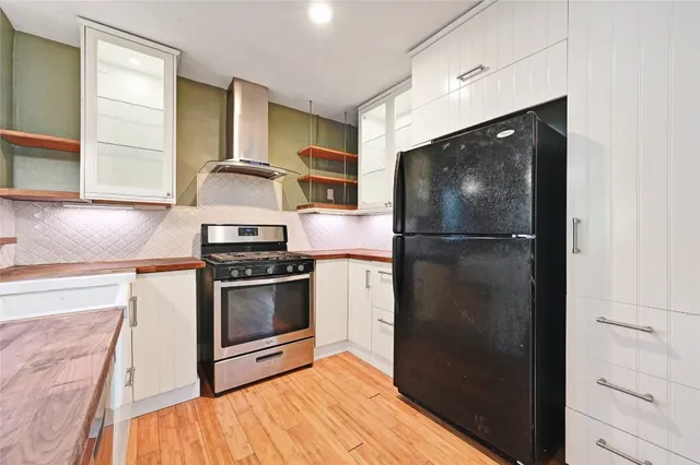 a kitchen with a refrigerator stove and sink