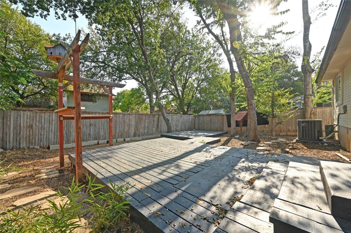 5304 China Berry Road Austin, TX 78744 - Photo 20 of 24 a view of a backyard with wooden fence and a large tree