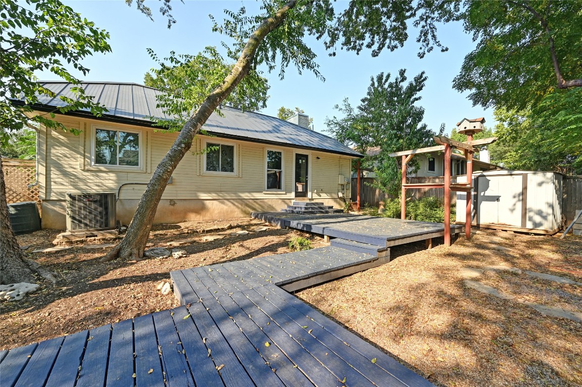 5304 China Berry Road Austin, TX 78744 - Photo 23 of 24 a view of a backyard with chairs and wooden floor