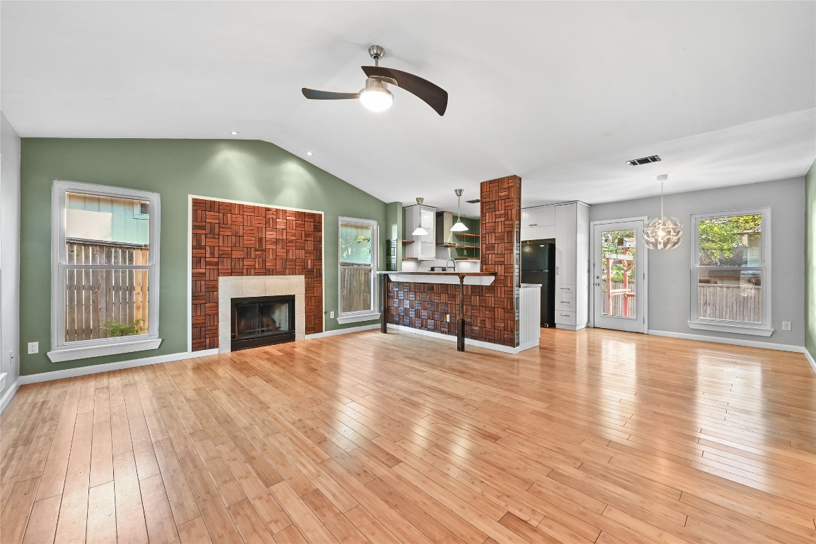 5304 China Berry Road Austin, TX 78744 - Photo 3 of 24 a view of an empty room with a fireplace and wooden floor