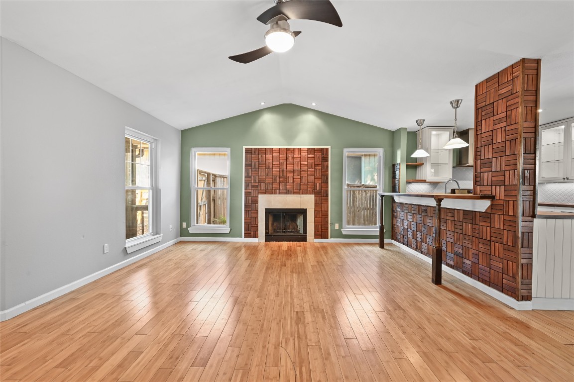 5304 China Berry Road Austin, TX 78744 - Photo 4 of 24 a view of an empty room with wooden floor fireplace and a window