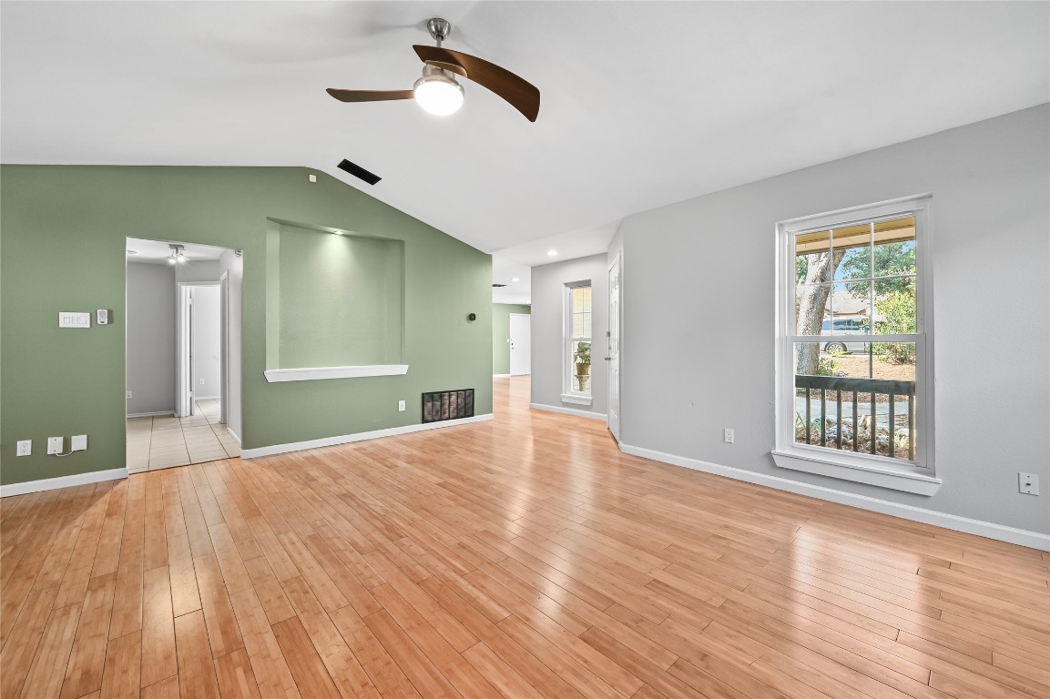 5304 China Berry Road Austin, TX 78744 - Photo 7 of 24 a view of an empty room with window and wooden floor