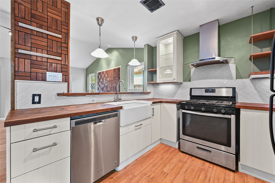 5304 China Berry Road Austin, TX 78744 - Photo 10 of 24 a kitchen with stainless steel appliances granite countertop a stove and a sink