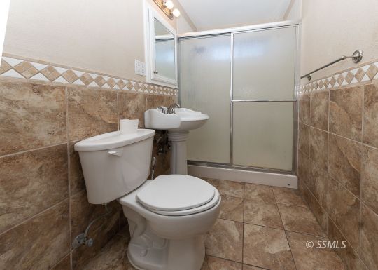 140 North Helena Street Ridgecrest, CA 93555 - Photo 14 of 30 a white toilet sitting next to a bathroom sink