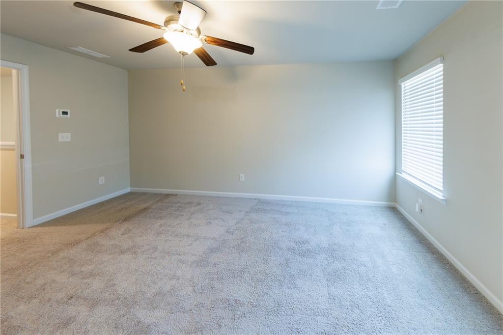 3375 Highbury Way Lithonia, GA 30038 - Photo 11 of 21 a view of a room with a ceiling fan and a window