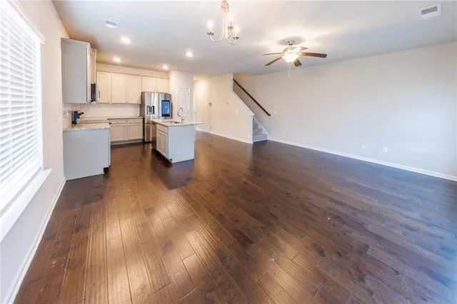a view of a kitchen with cabinets and wooden floor